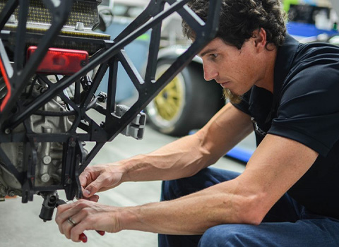 Mazda Motorsports Engineer Randy Miller working in the garage
