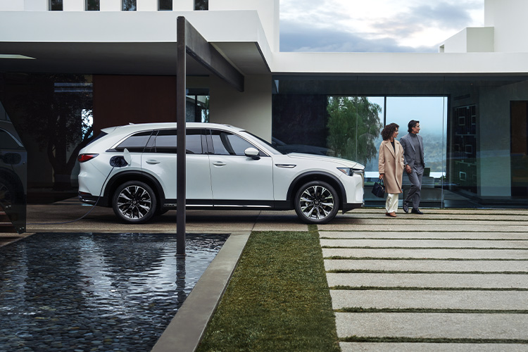 Electric Vehicle Buying Guide – Mazda CX-90 PHEV Parked by Pool